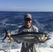 Blaise Jenner on boat holding large fish