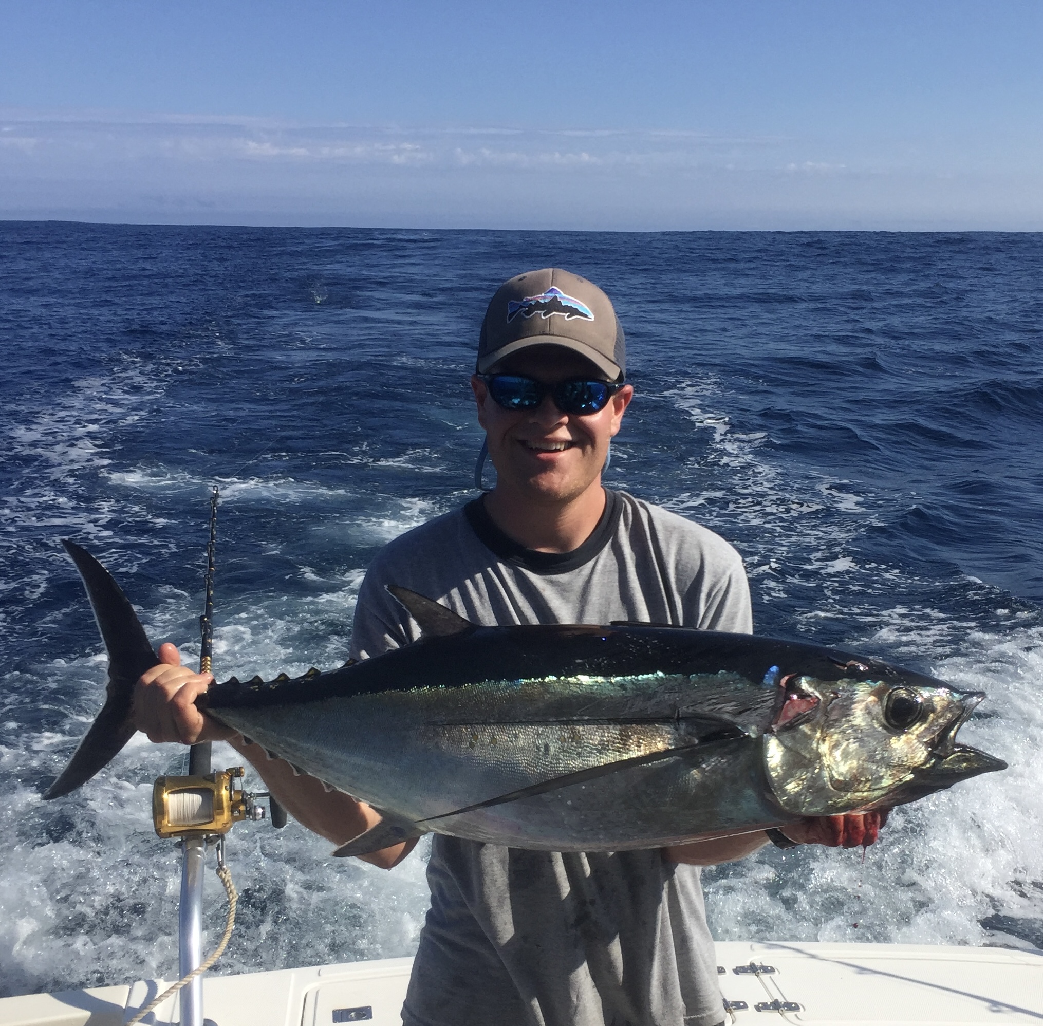 Blaise Jenner on boat holding large fish