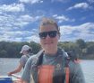 Chloe Root in sunglasses on a boat.