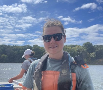 Chloe Root in sunglasses on a boat.