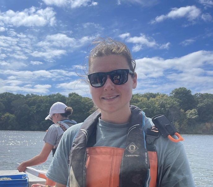 Chloe Root in sunglasses on a boat.