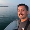 Selfie of Joseph Dello Russo by the ocean at sunset