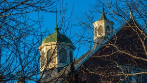 roof of Winslow Hall through tree twigs