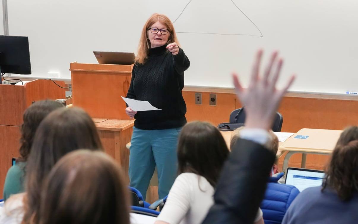 A photo of a professor at the front of a lecture hall