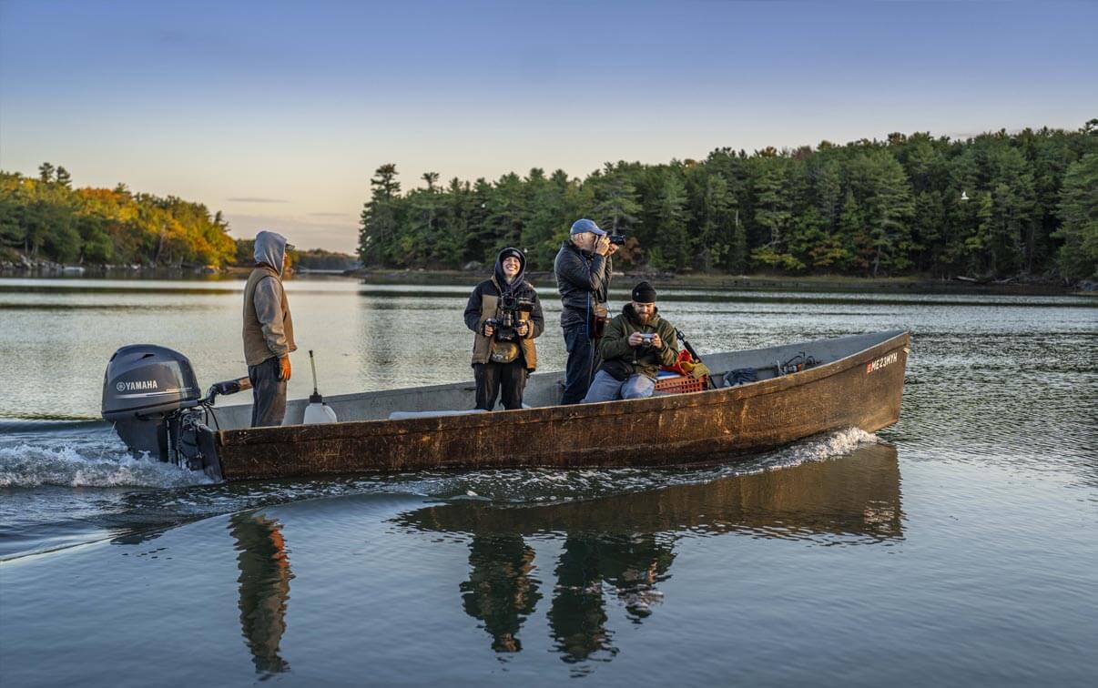 A photo of people with cameras on small boat