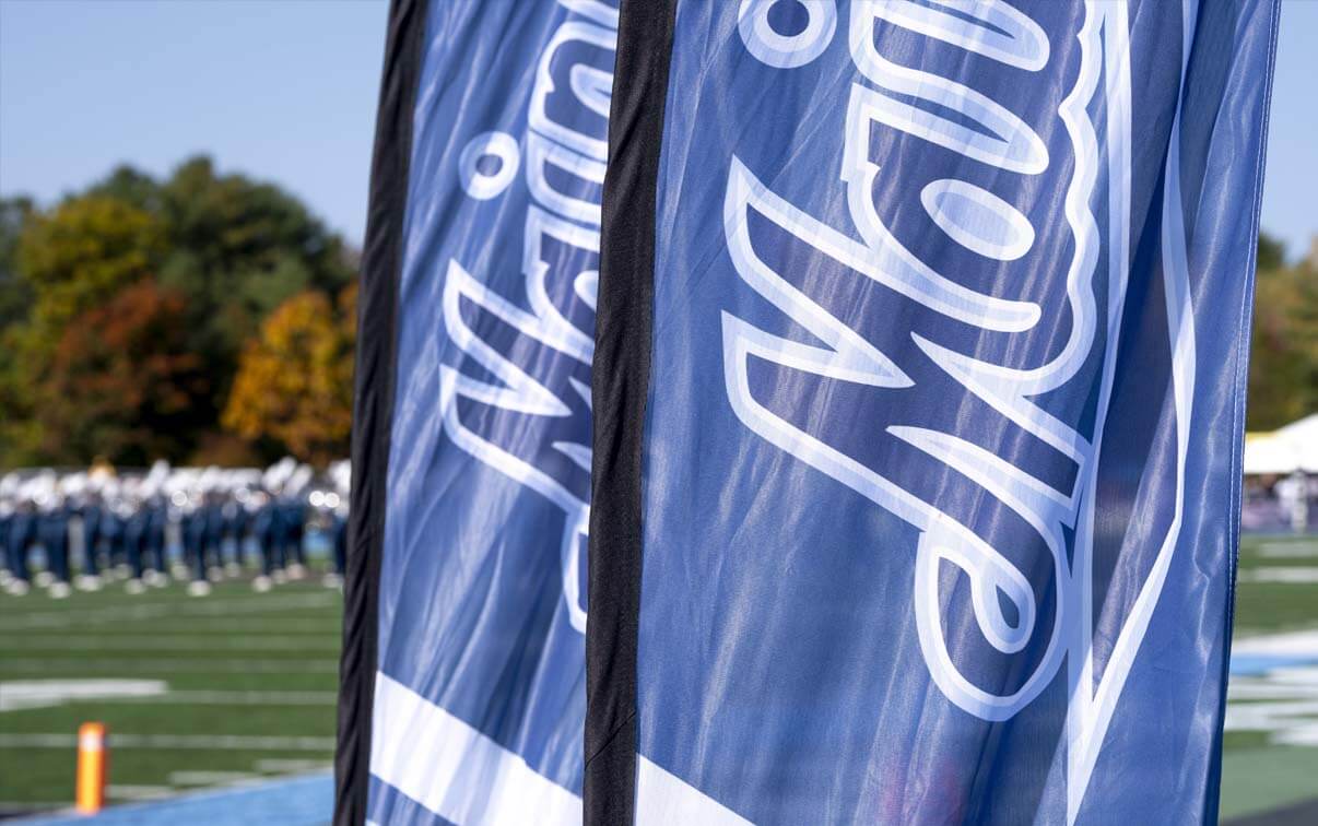 A photo of athletics field flags that read Maine