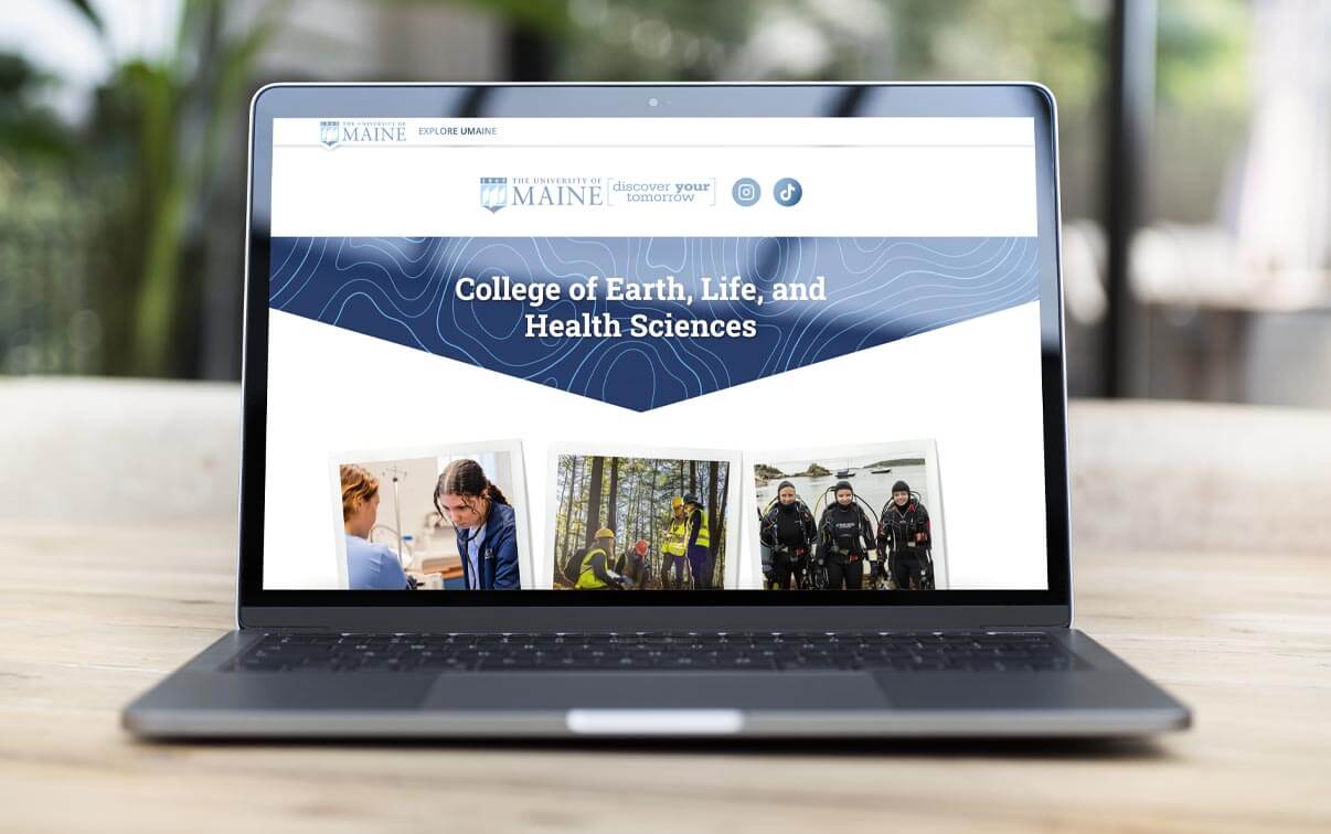 A laptop displaying a University of Maine website