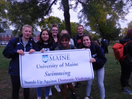 Swimming team stands against domestic violence