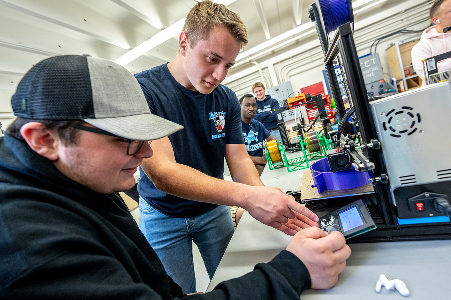 Electrical Engineering Technology students working on programming a machine