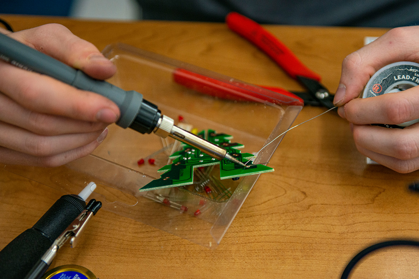 Electrical Engineering student working with tools and wires