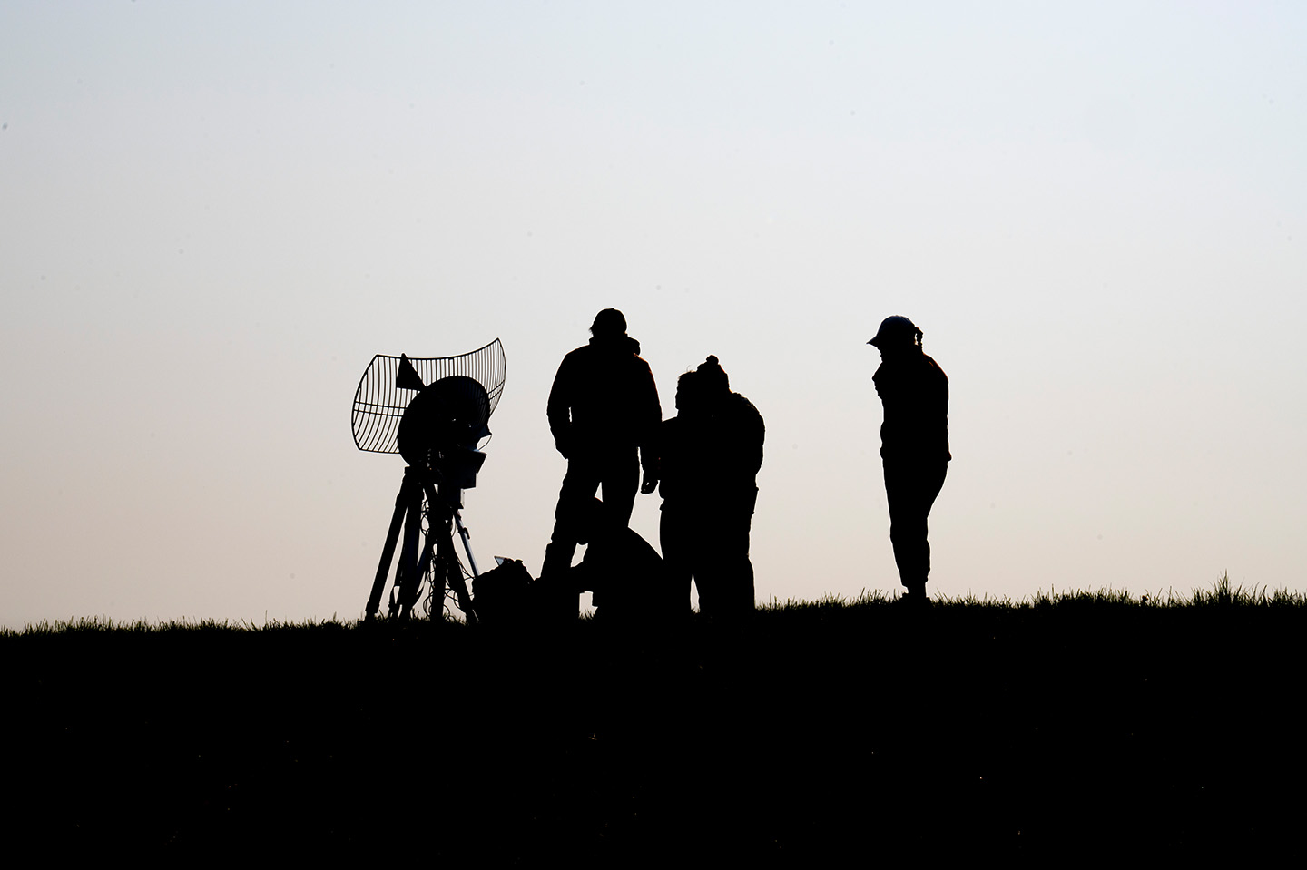 Four people at night doing the High Altitude Balloon launch