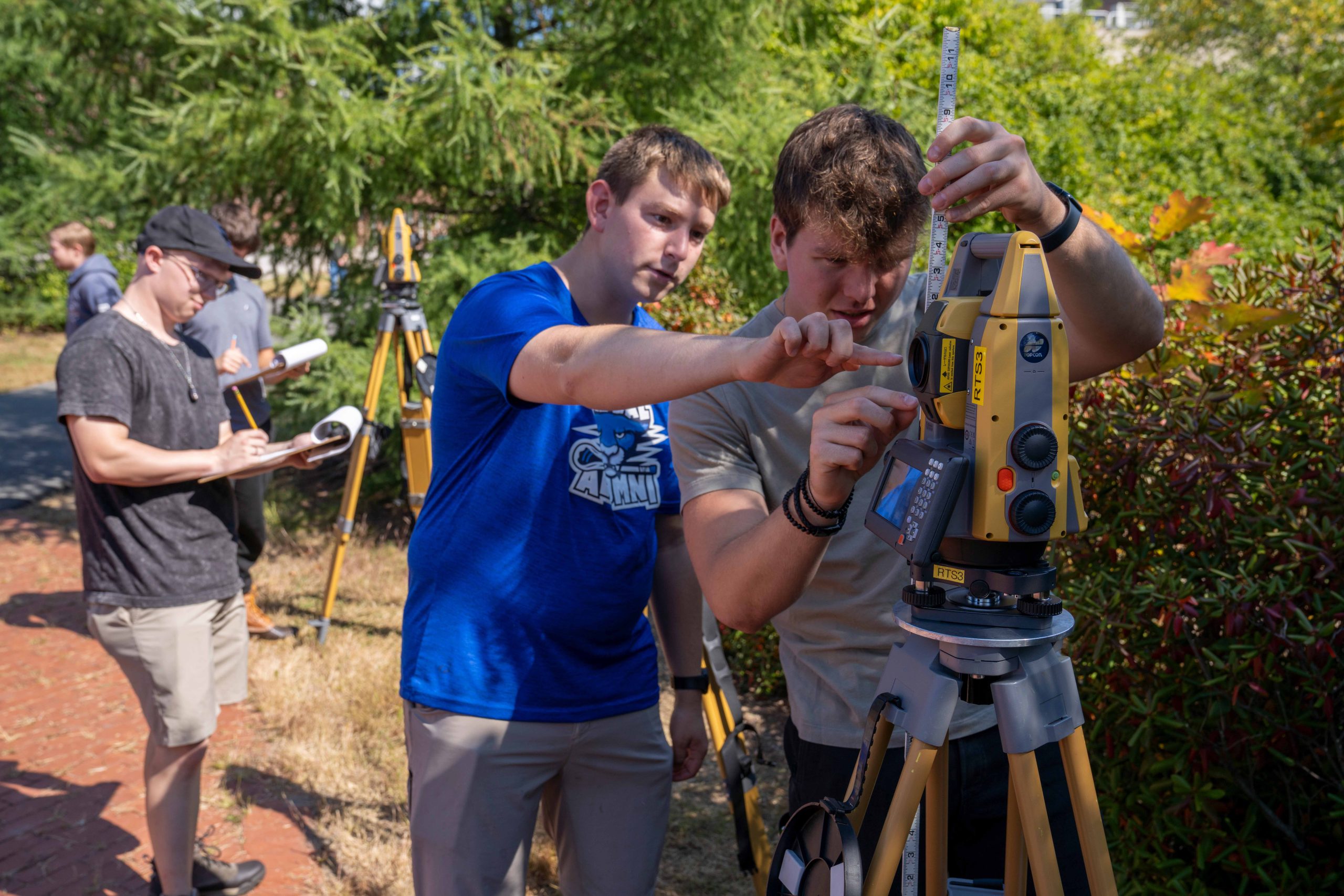 Surveying Engineering Technology students working in a lab outsite