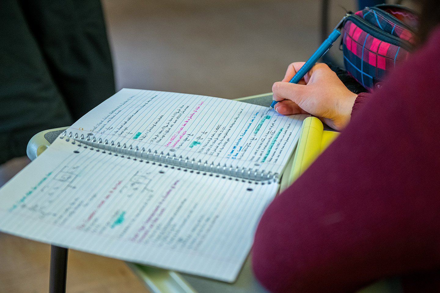 Student taking notes and studying  