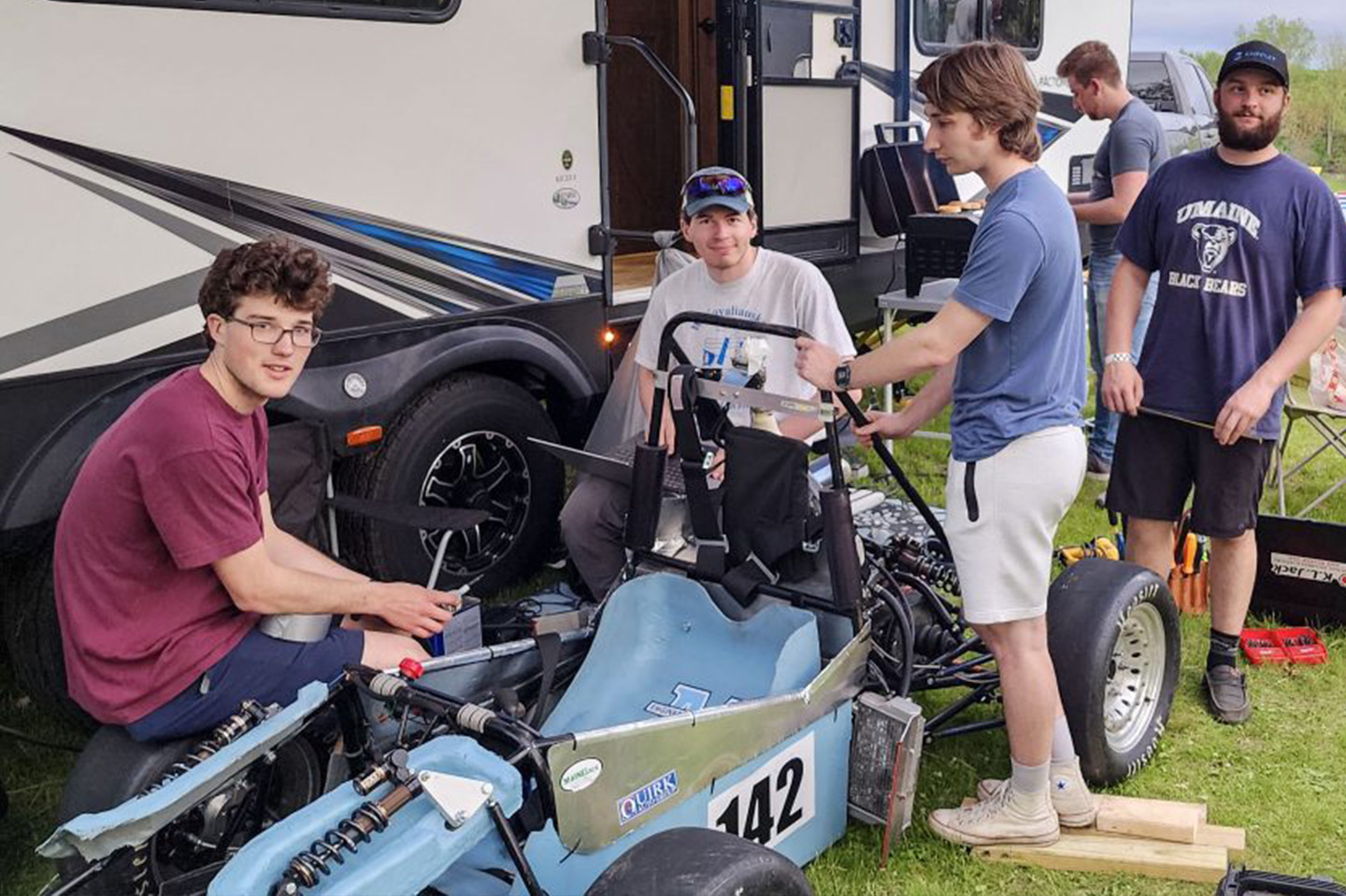 Engineering students working on a race car