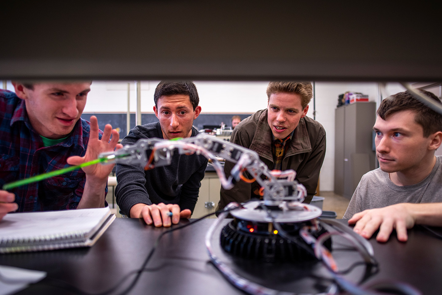 Robotics students working on advanced techniques to build a robot