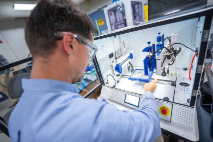 Mechanical Engineering student in a lab studying Advanced Materials, Mechanics, & Structures