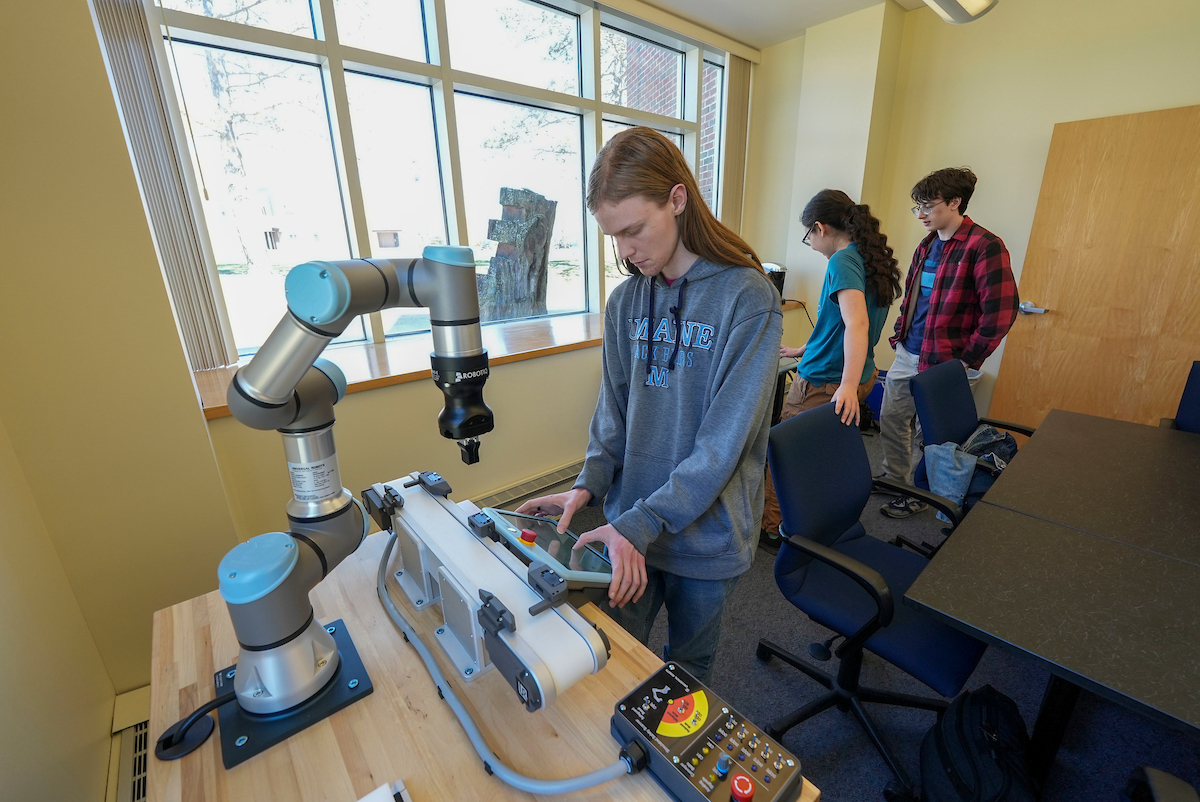 A photo of a teen working with robotics