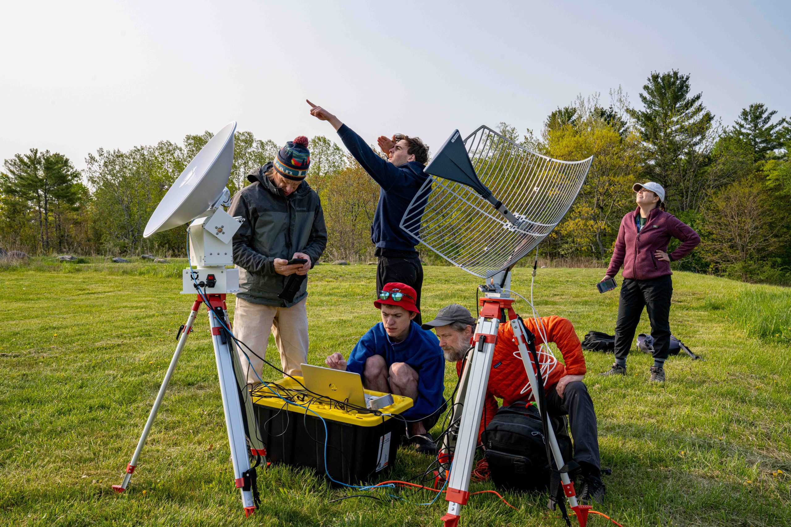 Students and professors outside with networking technology