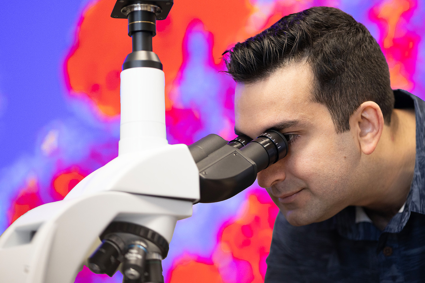 Engineer looking into a microscope