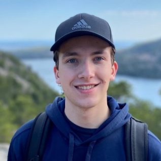 caucasian man wear blue shirt and baseball cap