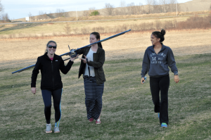 Photo of three students with an RC airplane