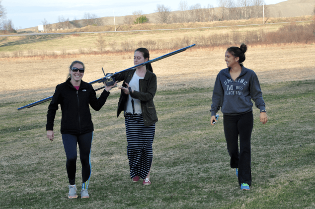 three students with flyer