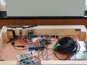 The top shelf, which is usually covered by the table top is now visile. here is where all the elctronics are located like the ELGOOs, the breadboards, the user interface, and the sensors.