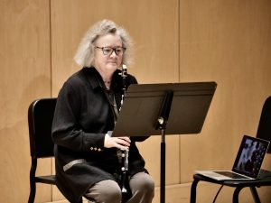 Photograph of Beth Wiemann, seated with clarinet