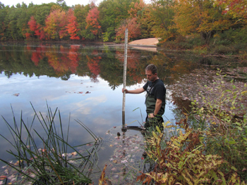 researcher measuring water depth