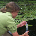 student taking water sample
