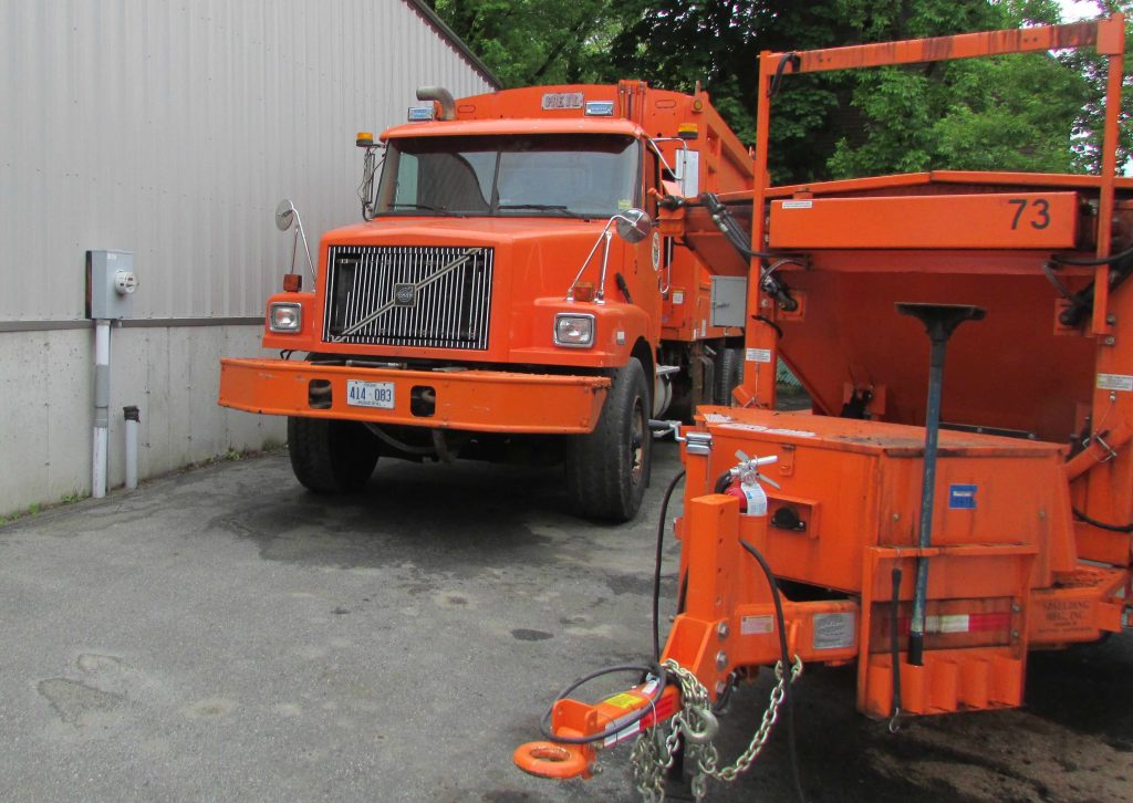 Image of orange garbage truck