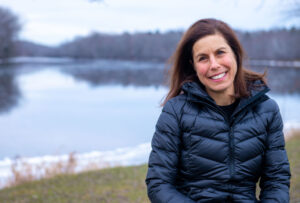 Jessica Jansujwicz in front of the Stillwater River in Orono Maine on a winter day