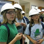 young students in hard hats