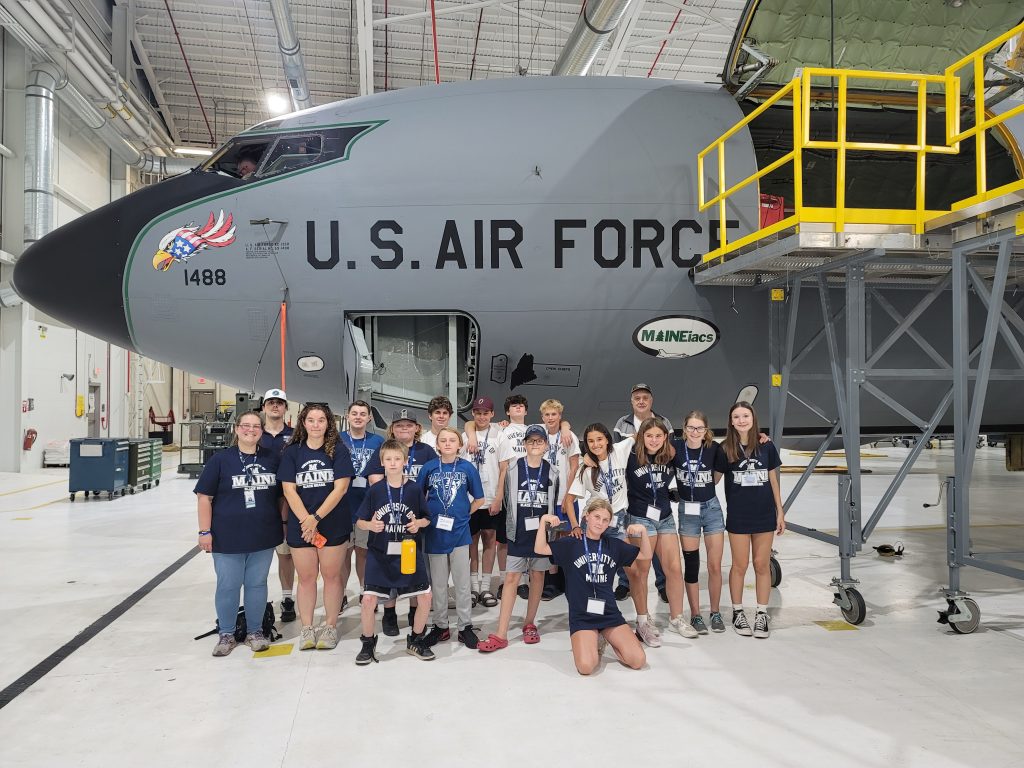 2023 MSTI Participants posing in front of the Maineiacs Air National Guard Airplane in a hanger.