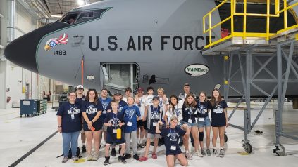 2023 MSTI Participants posing in front of the Maineiacs Air National Guard Airplane in a hanger.