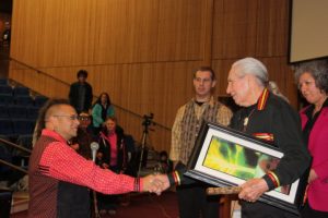 Gkisedtanamoogk giving Chief Oren Lyons a Painting