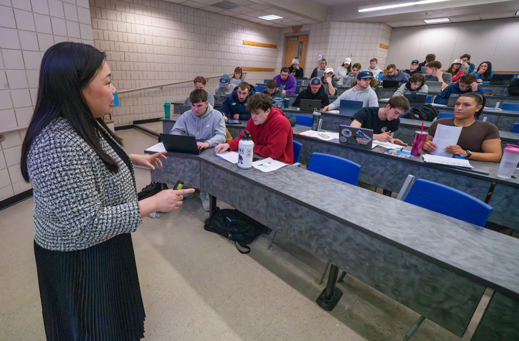 A photo of a faculty member teaching students