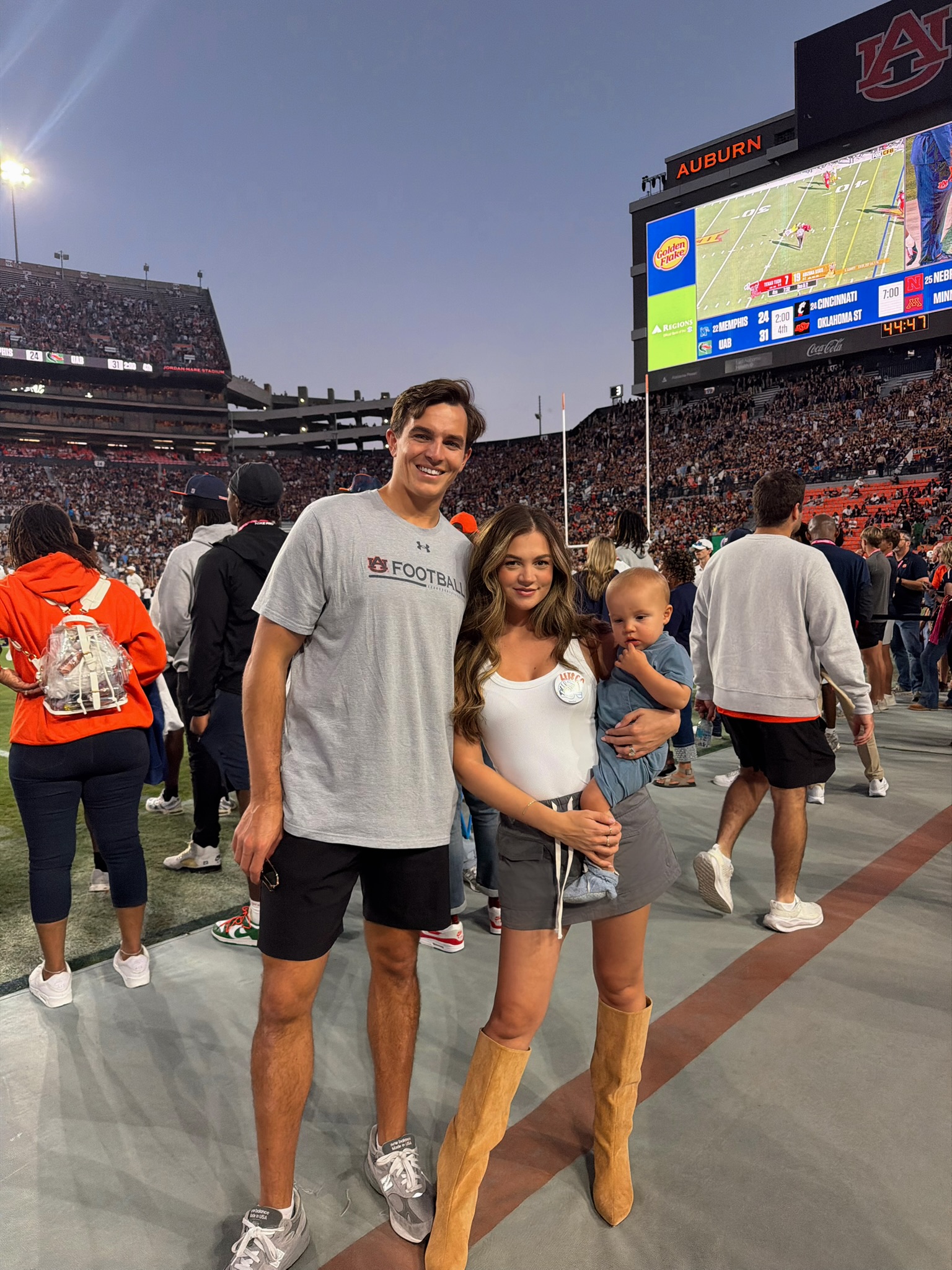 An image of Chris Ferguson, partner and baby in a football stadium