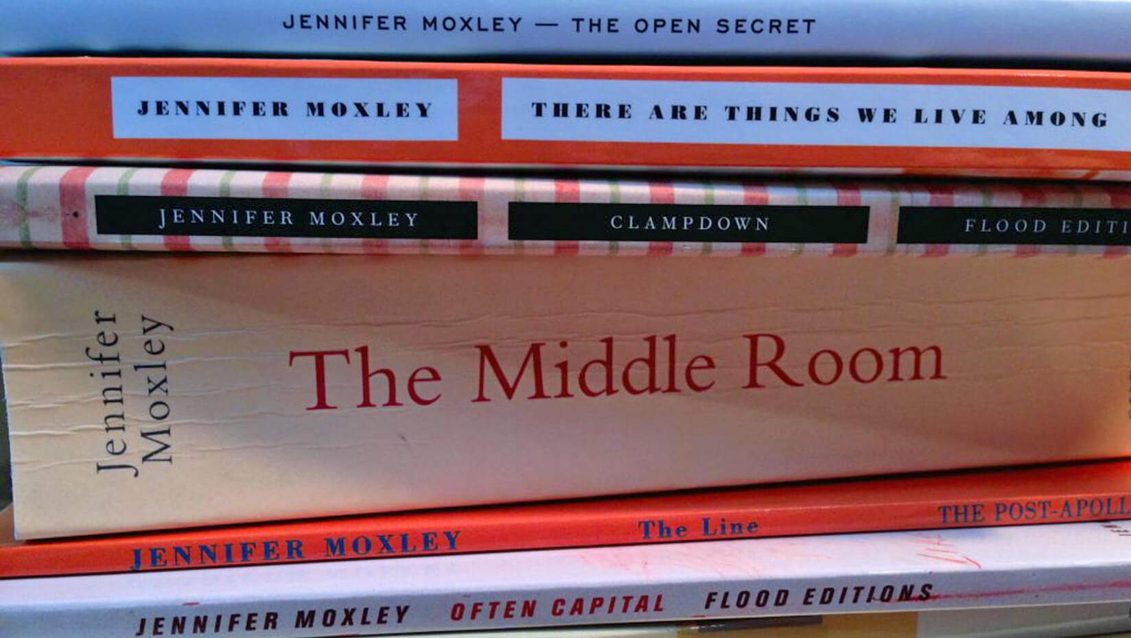 A stack of books written by Jennifer Moxley