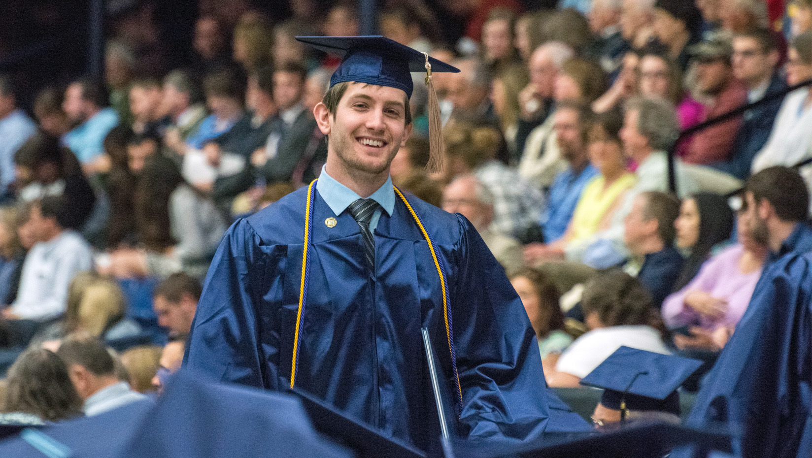 UMaine student in cap and gown at Commencement