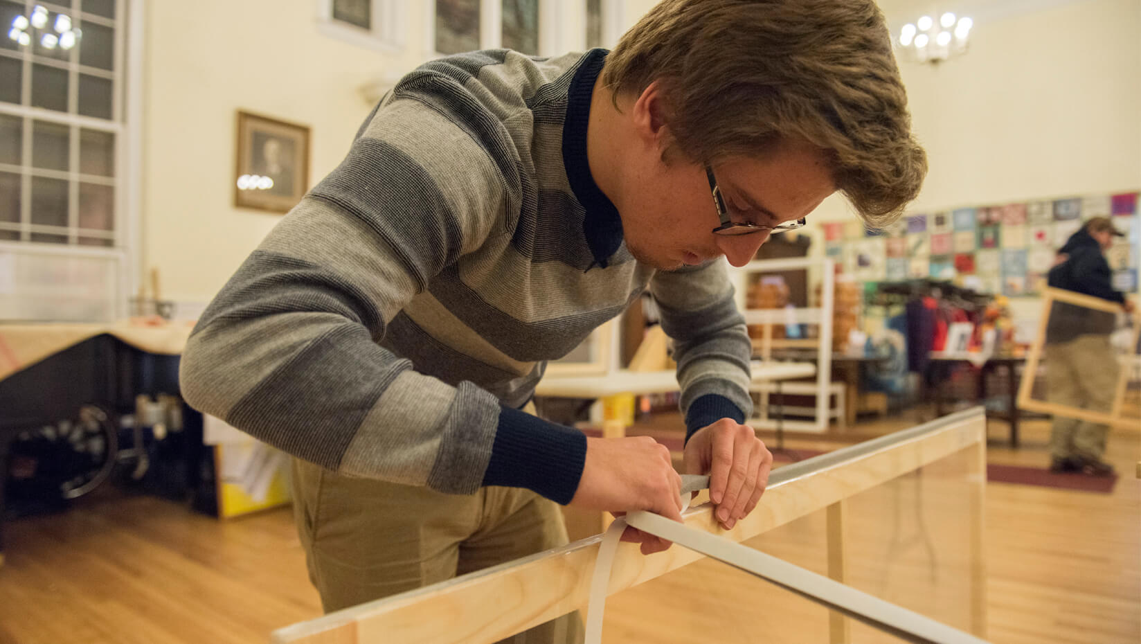 Student works on an energy-efficient window insert