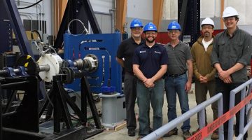ORPC and UMaine staff members standing nexts to tidal energy technology