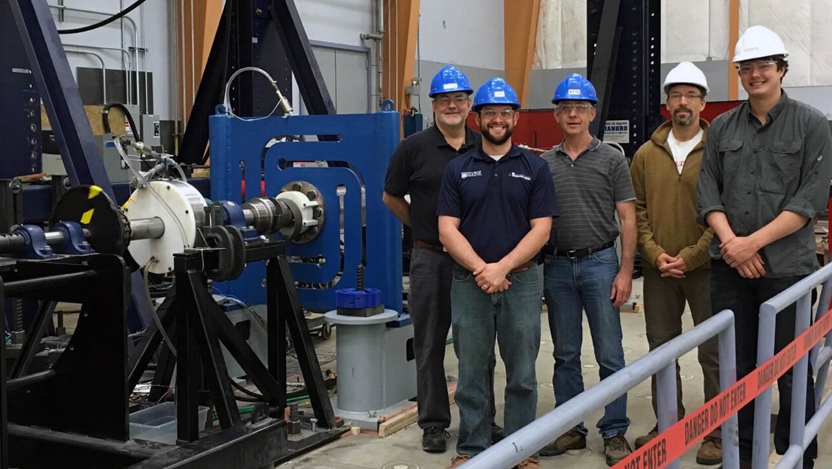 ORPC and UMaine staff members standing nexts to tidal energy technology