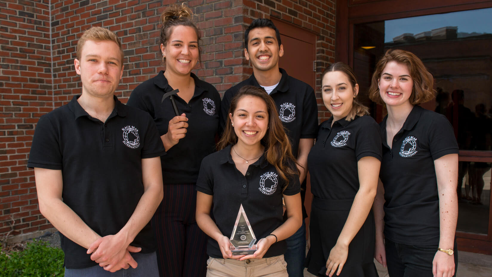 Maine Business School students posing with award