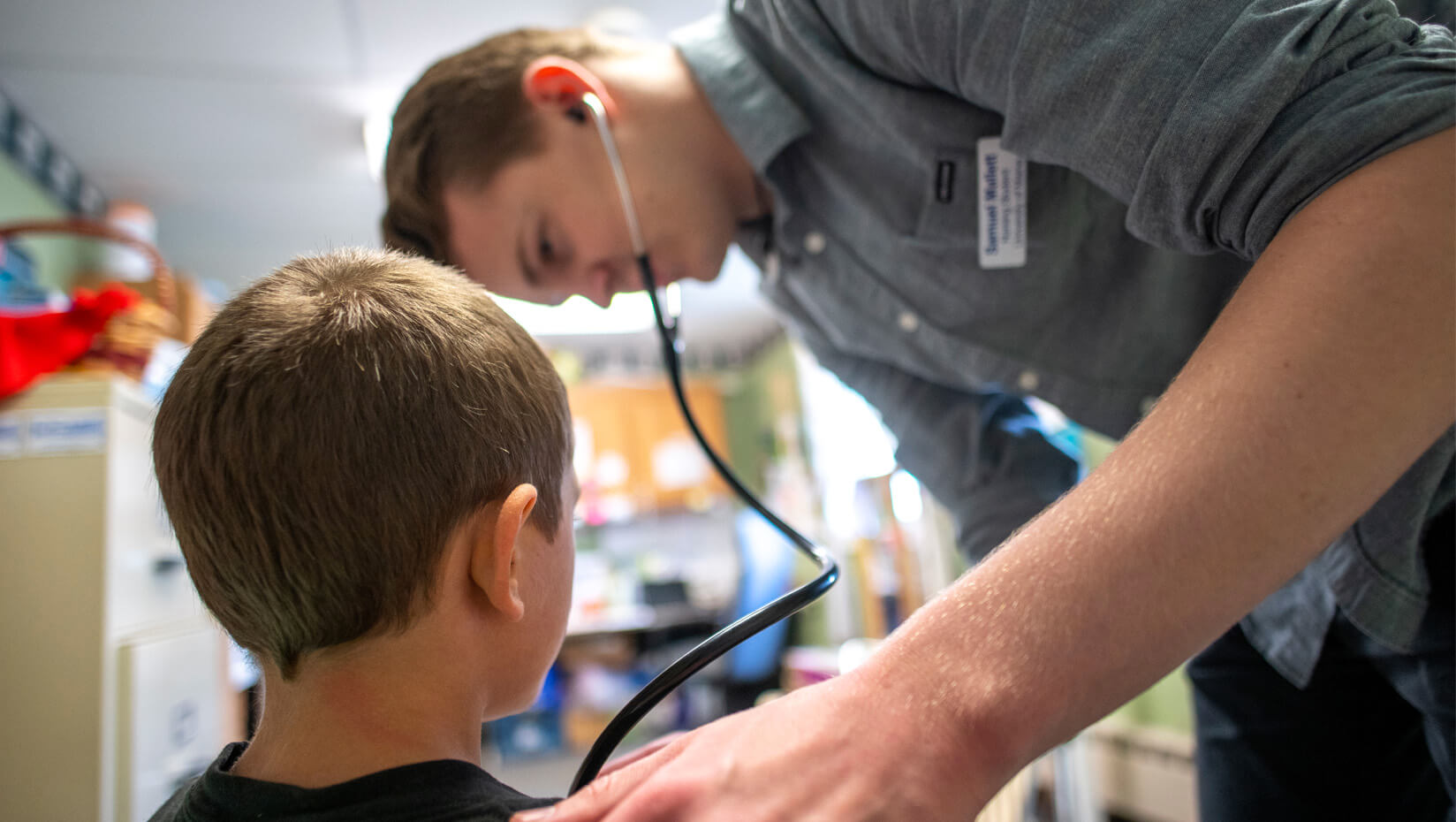 UMaine nursing student examines a child