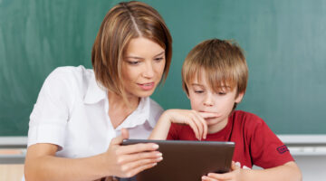 Teacher and student looking at a tablet
