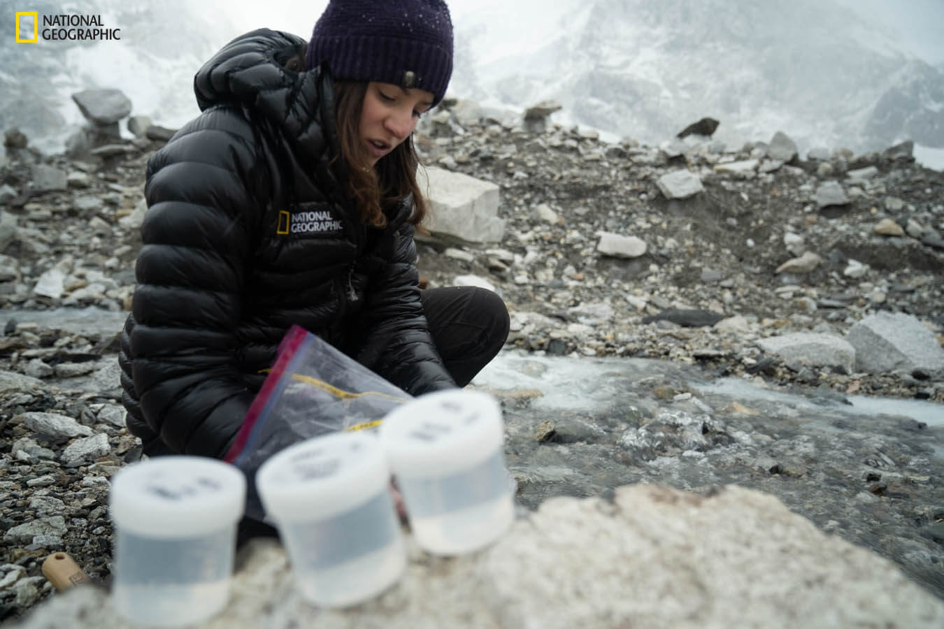 A woman collects samples near Mount Everest Base Camp.