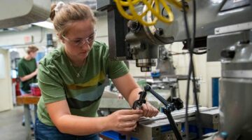 A woman works in UMaine's Advanced Manufacturing Center