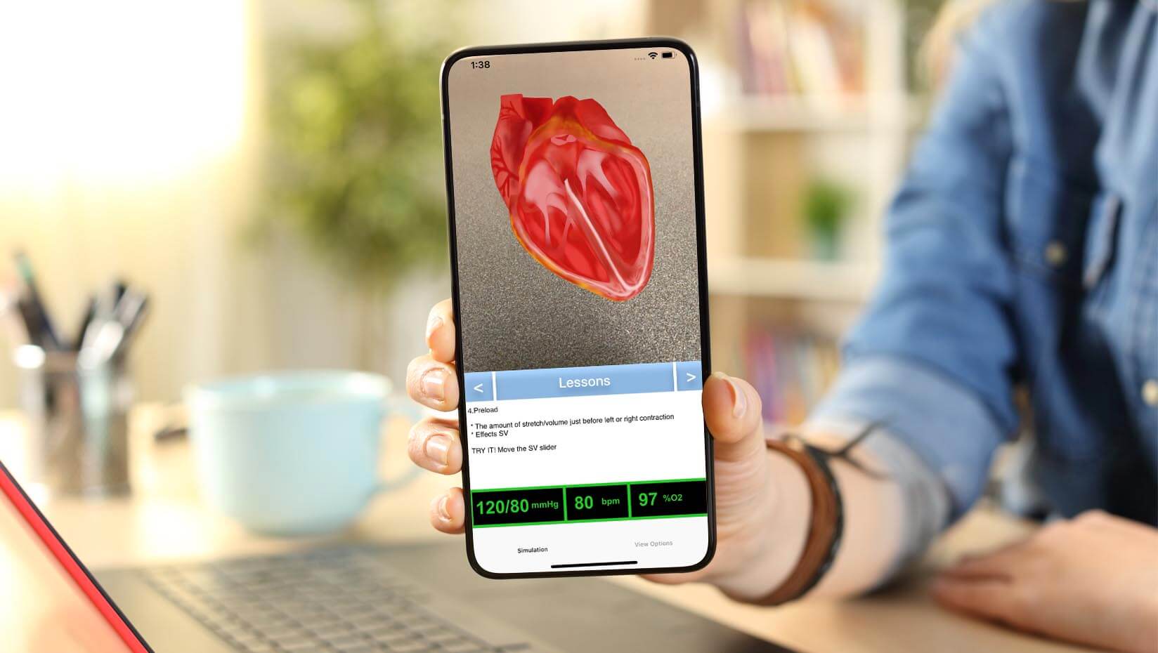 A student holds a smartphone showing an illustration of the human heart