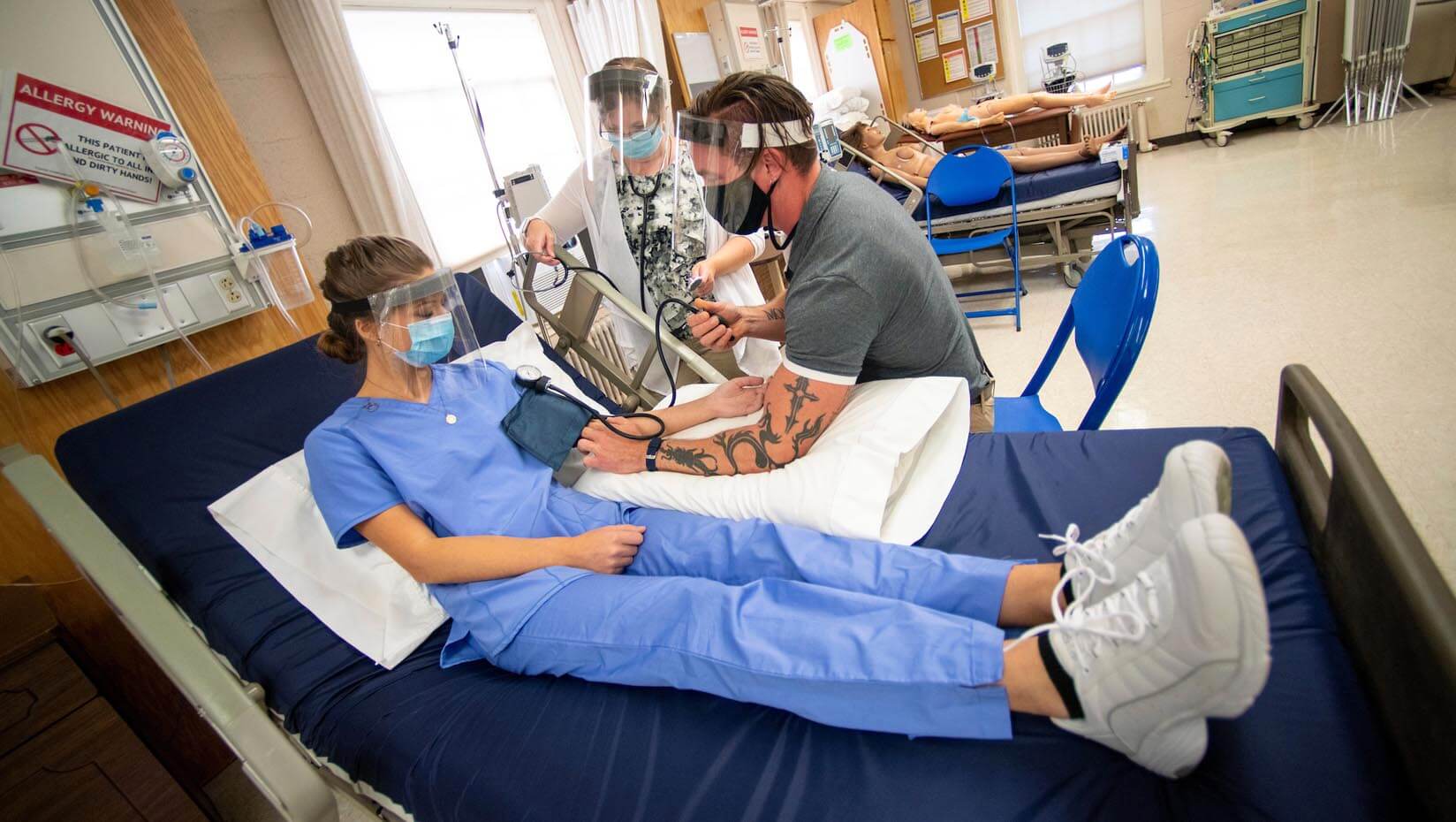 A photo of UMaine students working in a nursing lab